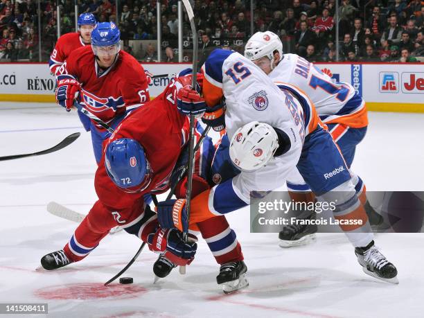 Erik Cole of the Montreal Canadiens faces off with Frans Nielsen of the New York Islanders during the NHL game on March 17, 2012 at the Bell Centre...