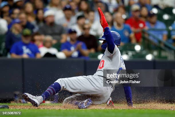 Mookie Betts of the Los Angeles Dodgers scores on a sacrifice fly in the fifth inning against the Milwaukee Brewers at American Family Field on...