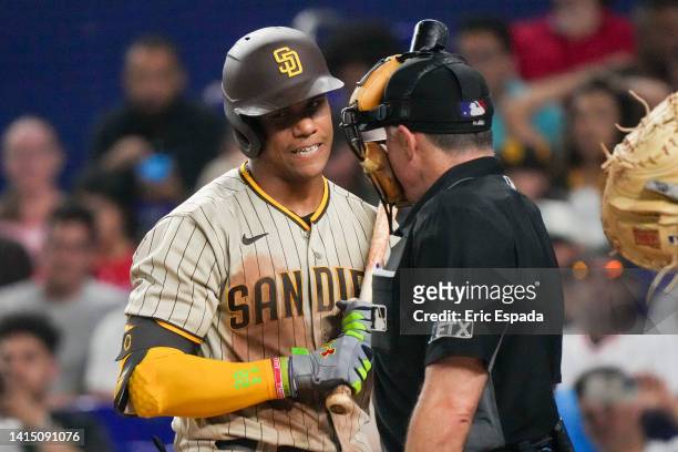 Juan Soto of the San Diego Padres talks with home plate umpire Dan Iassogna after striking out in the eighth inning against the Miami Marlins at...