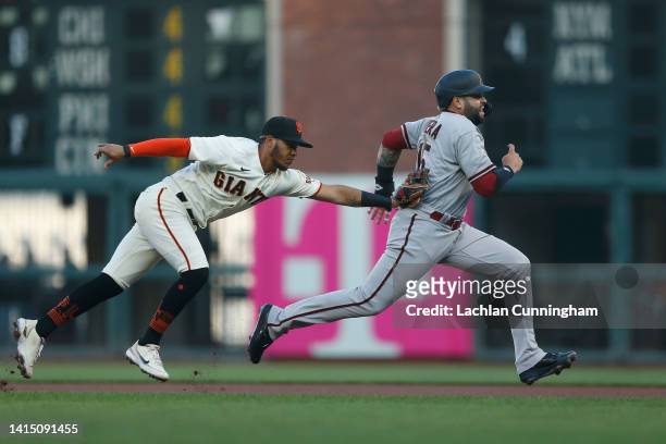 Emmanuel Rivera of the Arizona Diamondbacks is tagged out by Thairo Estrada of the San Francisco Giants after being caught in a rundown in the top of...
