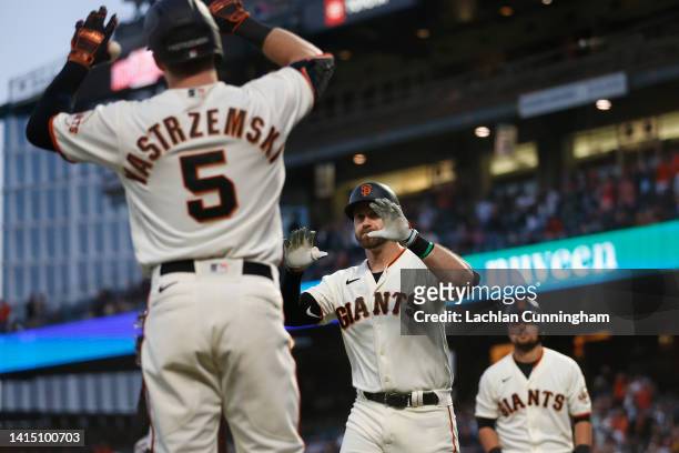Evan Longoria of the San Francisco Giants celebrates with teammates after hitting a two-run home run in the bottom of the fourth inning against the...