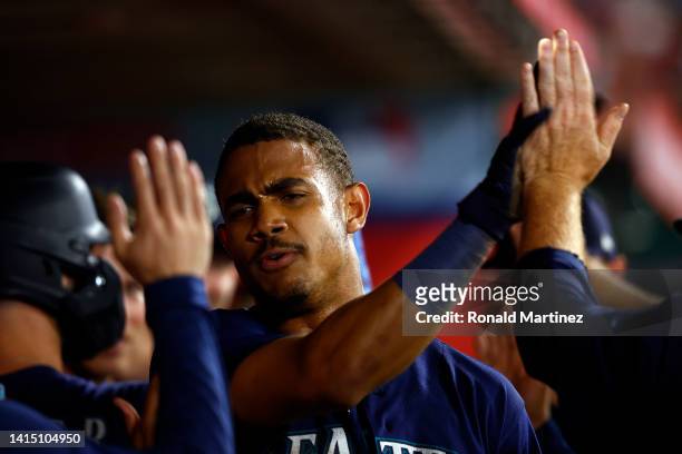 Julio Rodriguez of the Seattle Mariners celebrates a run against the Los Angeles Angels in the ninth inning at Angel Stadium of Anaheim on August 15,...