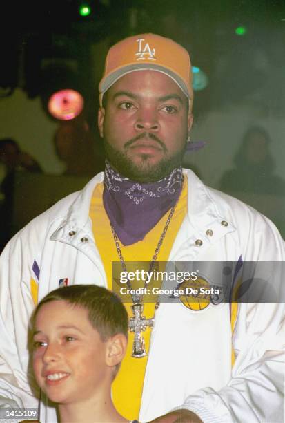 Ice Cube, rear, wears a Los Angeles Lakers home shooting shirt and tear-away pants during the NBA.com Celebrity Fashion Show Auction April 27, 2000...