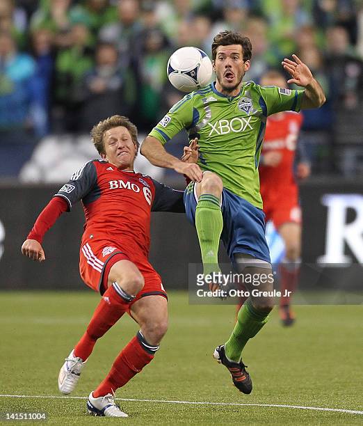 Brad Evans of the Seattle Sounders battles Terry Dunfield of Toronto FC at CenturyLink Field on March 17, 2012 in Seattle, Washington.