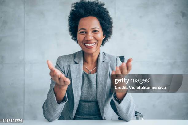 businesswoman talking during video call in the office. - digital video camera stock pictures, royalty-free photos & images