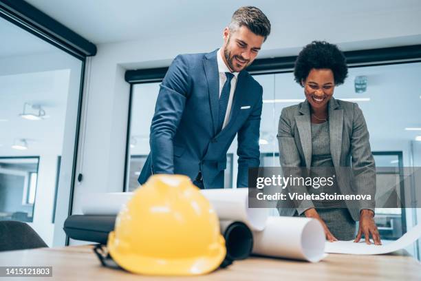 two architects discussing new project. - construction contract stock pictures, royalty-free photos & images