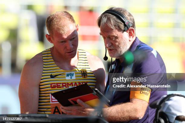 Arthur Abele of Germany talks to a referee after being disqualified from the event following a false start during the Men's Decathlon 110m Hurdles -...