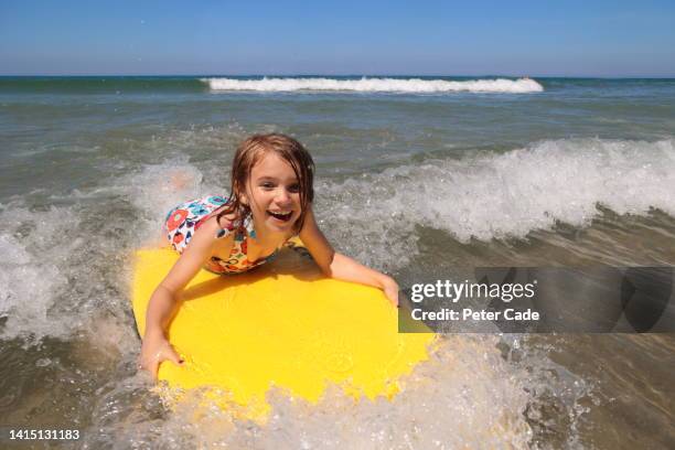 girl surfing on yellow surfboard - polzeath bildbanksfoton och bilder