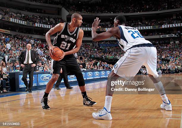 Tim Duncan of the San Antonio Spurs posts up against Ian Mahinmi of the Dallas Mavericks on March 17, 2012 at the American Airlines Center in Dallas,...