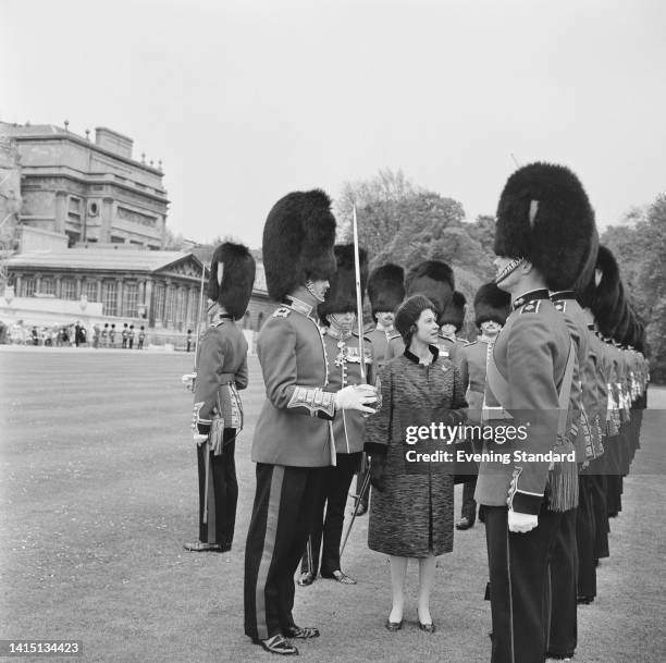 British Royal Queen Elizabeth II inspects the Grenadier Guards during a military inspection in the gardens of Buckingham Palace in London, England,...