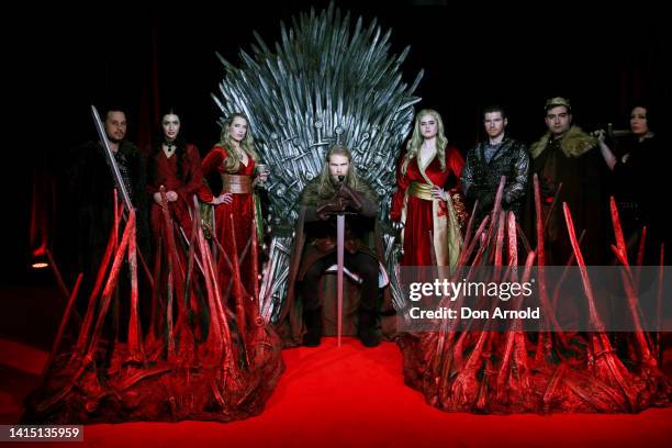 Models pose alongside a replica Iron Throne at the Australian Premiere of "House Of The Dragon" at Hoyts Entertainment Quarter on August 16, 2022 in...