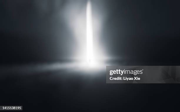 silhouette of anonymous person in dark tunnel with bright light - person spot light photos et images de collection