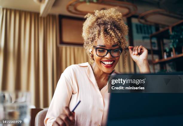 happy businesswoman talking on a video call meeting on her digital tablet in the cafe - voip stock pictures, royalty-free photos & images