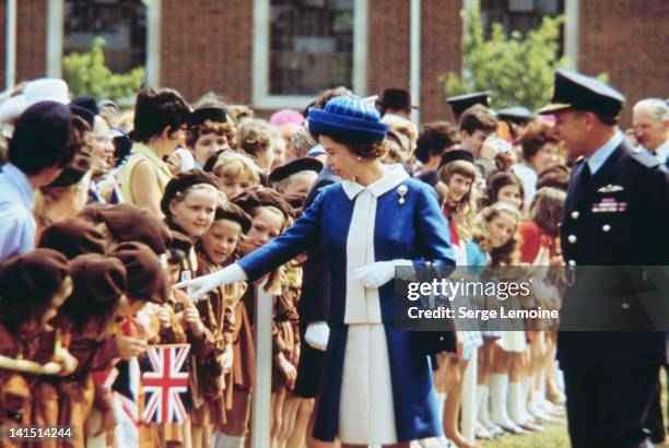 Queen Elizabeth II greets a group of brownies during her Silver Jubilee celebrations, England, 1977.