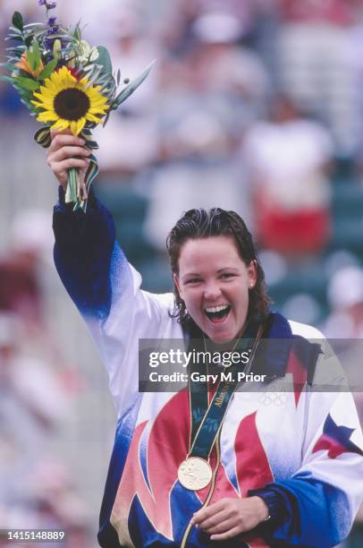 Lindsay Davenport from the United States celebrates on the winners podium with the gold medal after defeating silver medalist Arantxa Sánchez Vicario...