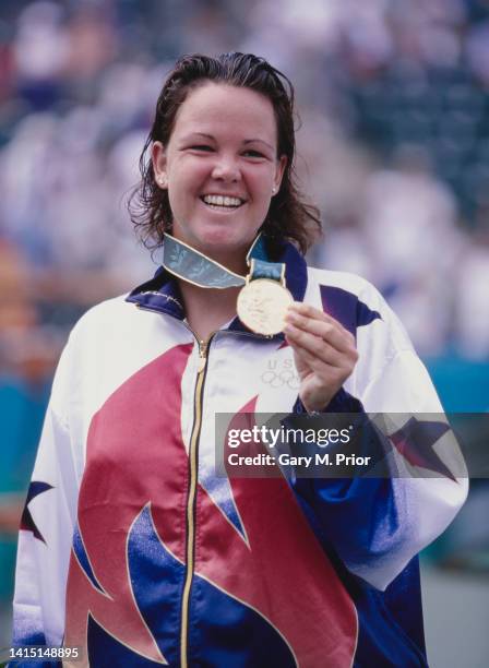 Lindsay Davenport from the United States celebrates on the winners podium with the gold medal after defeating silver medalist Arantxa Sánchez Vicario...