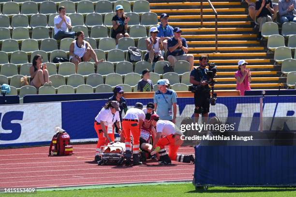 Axel Vang Christensen of Denmark receives medical attention in the Men's 3000m Steeplechase Round 1 - Heat 1 during the Athletics competition on day...