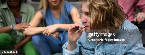 young teenager smoking marihuana cigarettes. - smoking weed stock pictures, royalty-free photos & images