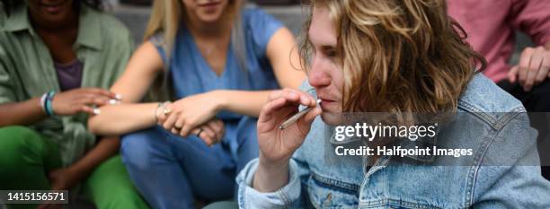 young teenager smoking marihuana cigarettes. - boys smoking cigarettes stock pictures, royalty-free photos & images