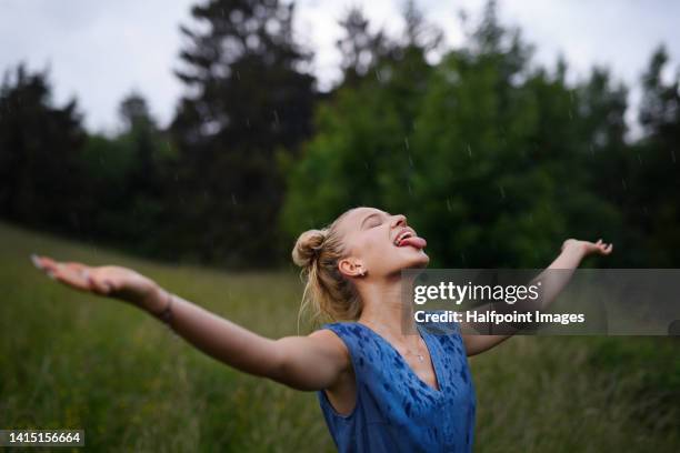 portrait of beautiful blond woman standing in rain. - pendentif femme photos et images de collection