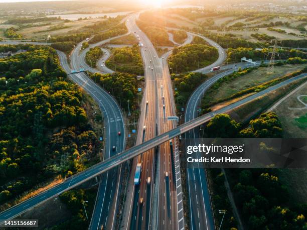 an aerial sunset view of a multi-lane road intersection - autosnelweg stockfoto's en -beelden