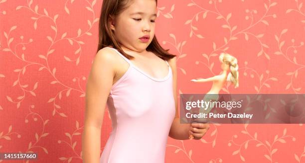 child comparing her body to her doll's - body dysmorphia stock pictures, royalty-free photos & images