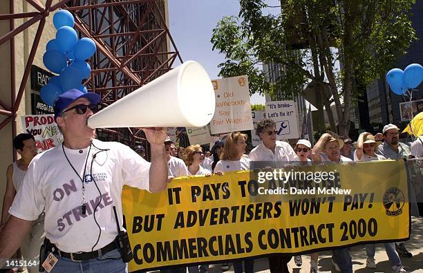 Los Angeles strike coordinator Gordon Drake leads striking actors from SAG and AFTRA actors unions in a chant while marching down Wilshire Blvd. To...