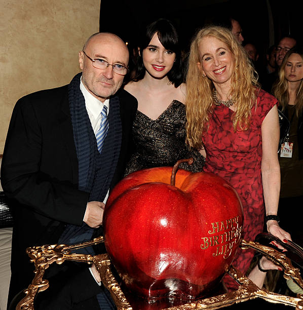 Musician Phil Collins, his daughter actress Lily Collins and her mom Jill Tavelman pose with Lily's birthday cake at the after party for the premiere...