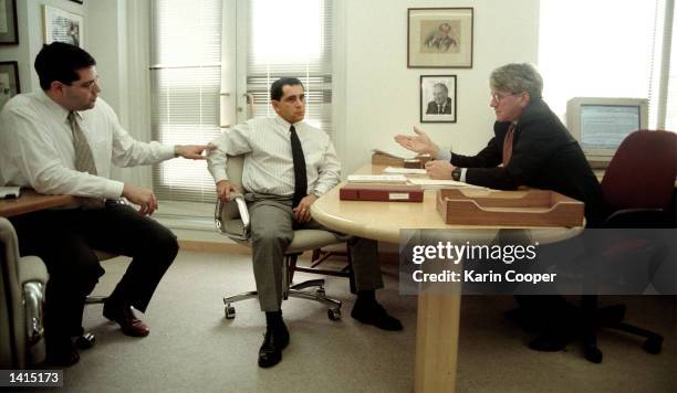 Juan Miguel Gonzalez, center, speaks with attorney Gregory Craig, right, and spanish speaking attorney Oliver Garcia, left, in Craig''s office April...