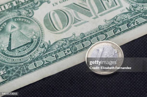 one euro and one dollar together on a black background - moneta da un euro foto e immagini stock