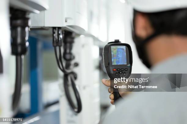 thermal imaging-based maximum power point tracking for solar inverter modules in variable ambient temperature. electrician engineer used a thermal imaging camera to examine hot spots on balance-of-system wire and equipment. - thermal image stock pictures, royalty-free photos & images