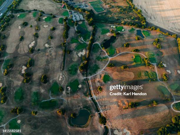 an aerial sunset view of a golf course - golf eng stock pictures, royalty-free photos & images