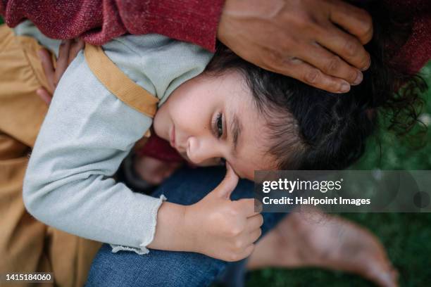 sad little multiracial girl in mother arms, worrying. - domestic violence home stock pictures, royalty-free photos & images