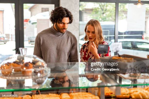 couple in bakery - couple choosing stock pictures, royalty-free photos & images