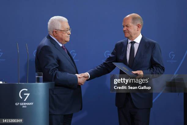 Mahmoud Abbas , President of the Palestinian National Authority, and German Chancellor Olaf Scholz shake hands after speaking to the media following...