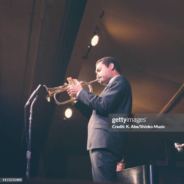 Art Farmer plays the flugel horn to the mic, location unknown, circa 1970s.