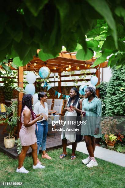 smiling young pregnant woman celebrating baby shower with best friends. - baby shower party stock pictures, royalty-free photos & images