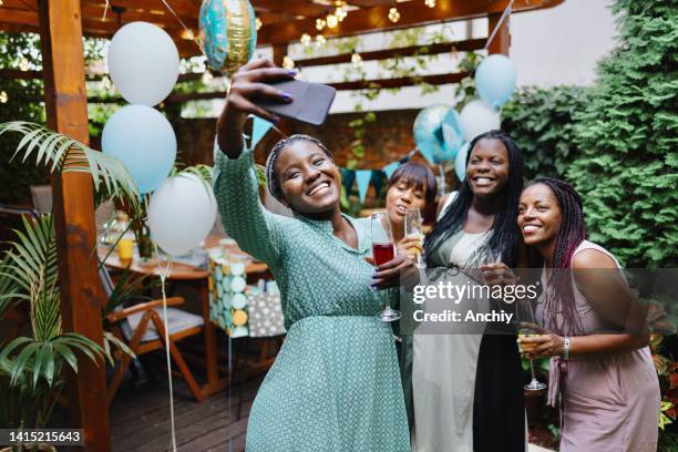 group of female friends taking selfies at a baby shower - baby shower stock pictures, royalty-free photos & images