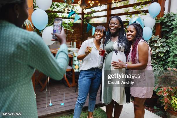 group of women taking photos during a baby shower - outdoor baby shower stock pictures, royalty-free photos & images