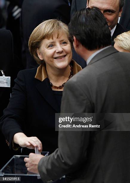 German Chancellor Angela Merkel casts her ballot at the Bundestag for the election of a new German President by the Federal Assembly on March 18,...