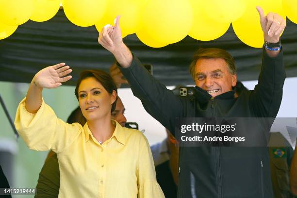 President of Brazil Jair Bolsonaro, who is running for re-election, and her wife Michelle Bolsonaro acknowledge the crowd during his first campaign...