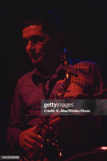 Art Pepper holds his alto saxophone in dark, location unknown, circa 1970s.