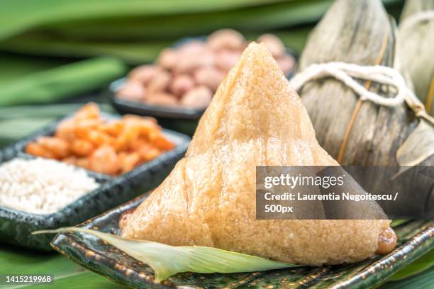 close up,copy space,famous chinese food in dragon boat duan wu festival,steamed rice dumplings - alpinia zerumbet stock pictures, royalty-free photos & images