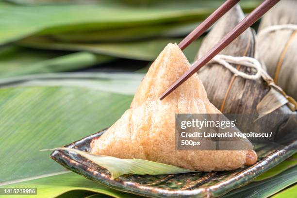 close up,copy space,famous chinese tasty food in dragon boat duan wu festival,steamed rice dump - alpinia zerumbet stock pictures, royalty-free photos & images