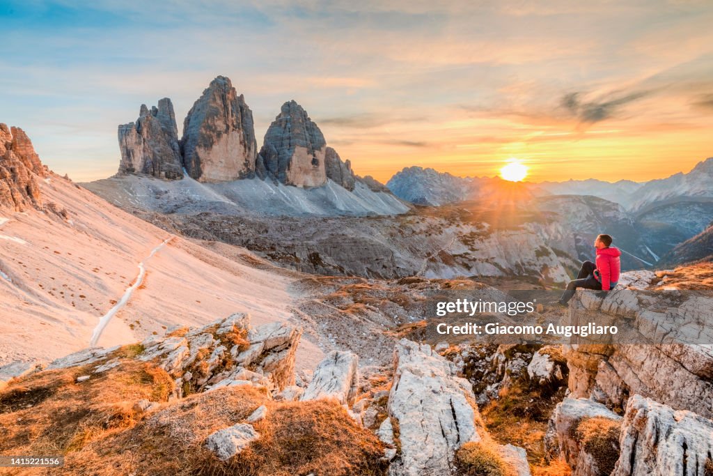 Man sitting in front of Three Peaks of Lavaredo, Dolomites, South Tyrol