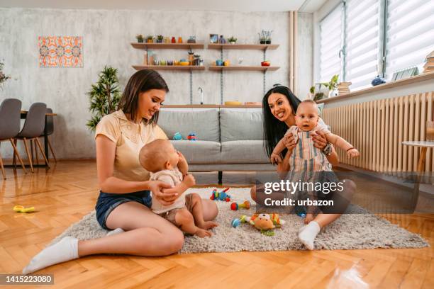 two young mothers having a play date with their baby boys - play date imagens e fotografias de stock