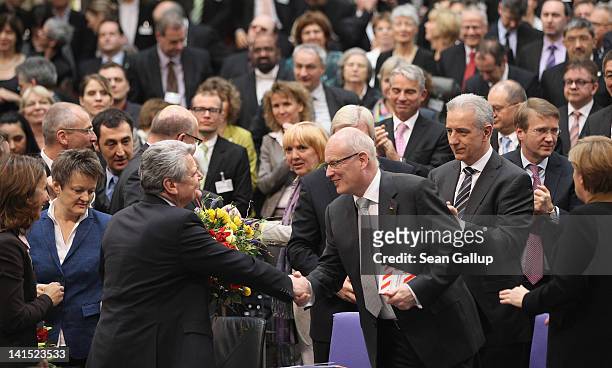 Joachim Gauck , Lutheran pastor and former East German human-rights activist, is congratulated by Christian Democrat Volker Kauder at the Bundestag...