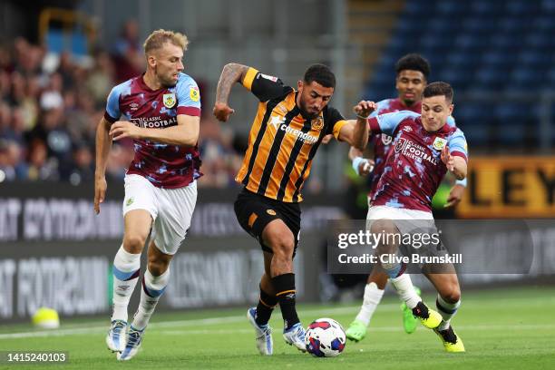 Allahyar Sayyadmanesh of Hull City is challenged by Josh Cullen and Charlie Taylor of Burnley during the Sky Bet Championship between Burnley and...