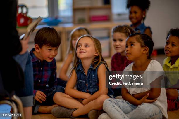 kindergarten students listening to a story - arab student kids stock pictures, royalty-free photos & images