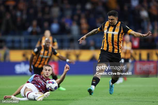 Taylor Harwood-Bellis of Burnley is challenged by Oscar Estupinan of Hull City during the Sky Bet Championship between Burnley and Hull City at Turf...